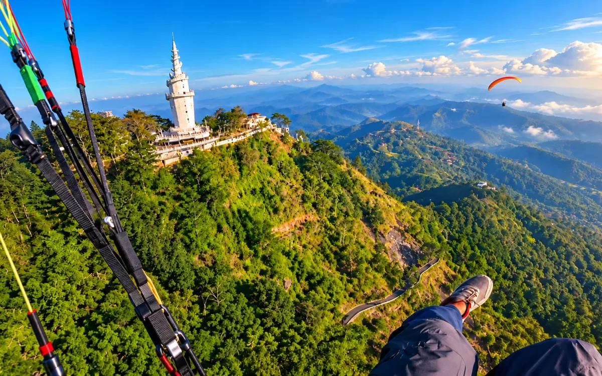 Paraglider flying beside the Ambuluwawa spiral tower above Gampola